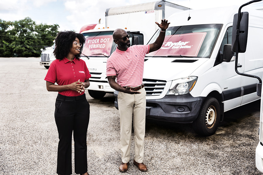 Ryder employee and customer looking at used trucks