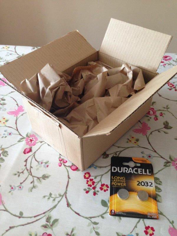 a small package of two duracell batteries next to the large box that it arrived in.