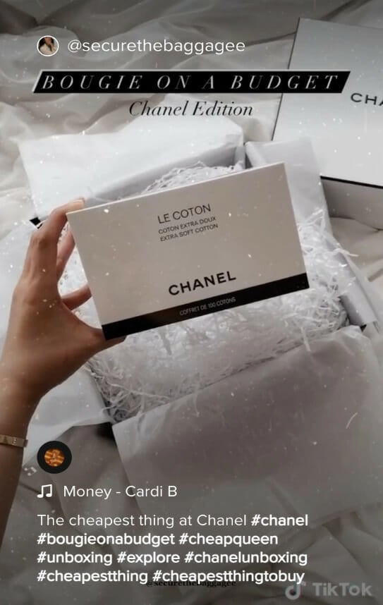 screenshot of a TikTok showing the unboxing of the cheapest thing at chanel, cotton pads