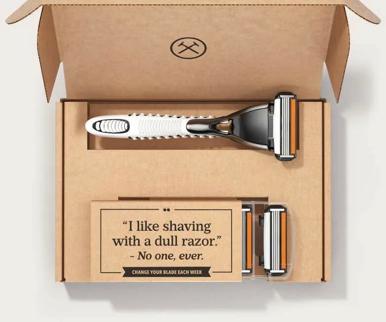 A razor and refills packaged from the dollar shave club.