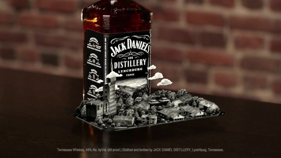 an augmented reality view of a bottle of jack daniels surrounded by a miniature version of their distillery