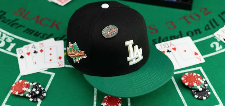 a baseball hat from lids sitting on a poker table with cards and chips