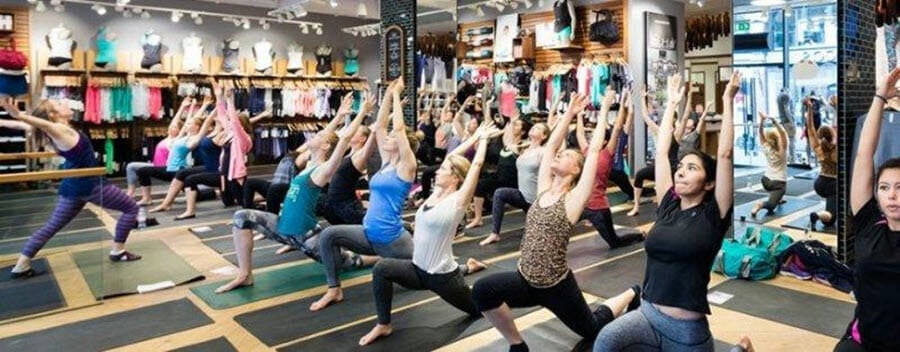 Women doing yoga inside of a lululemon store