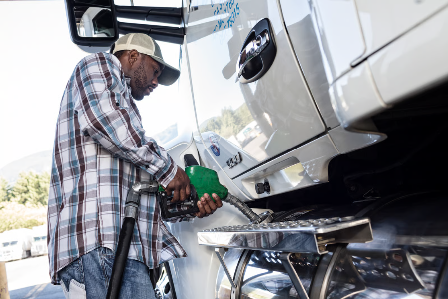 Preventing Misfuelling and DEF Contamination A truck driver puts fuel into his big rig