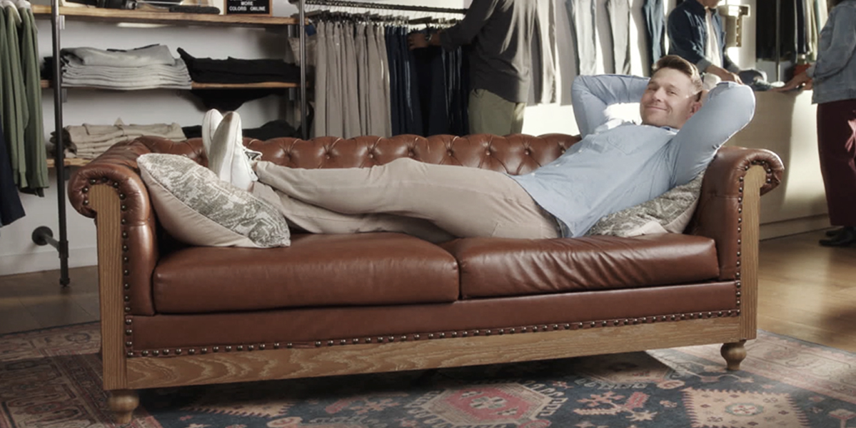 Mike McGee of Mugsy jeans laying on a couch Mike McGee of Mugsy jeans laying on a couch