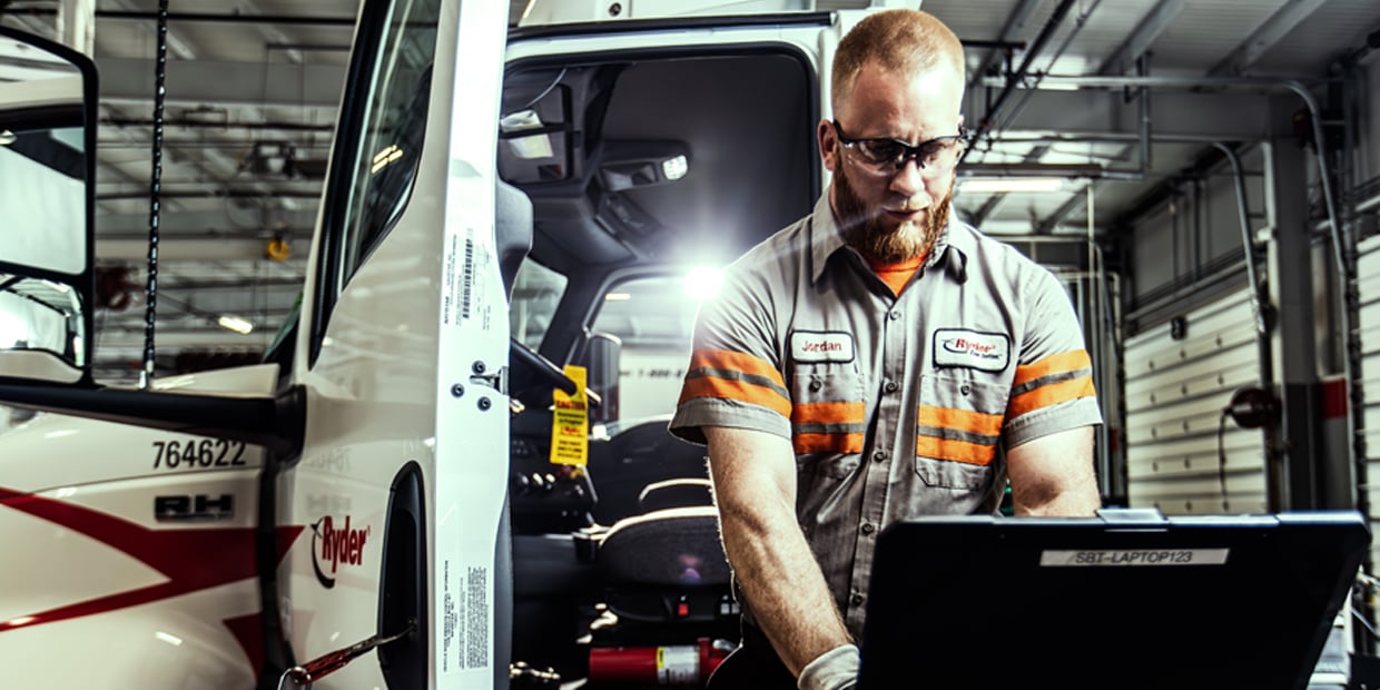 Truck Leasing & Maintenance Ryder technician performing maintenance on a semi truck
