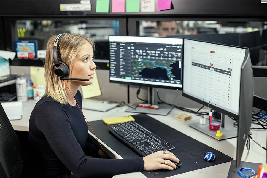 Ryder transportation control tower specialist monitoring inbound freight on multiple screens