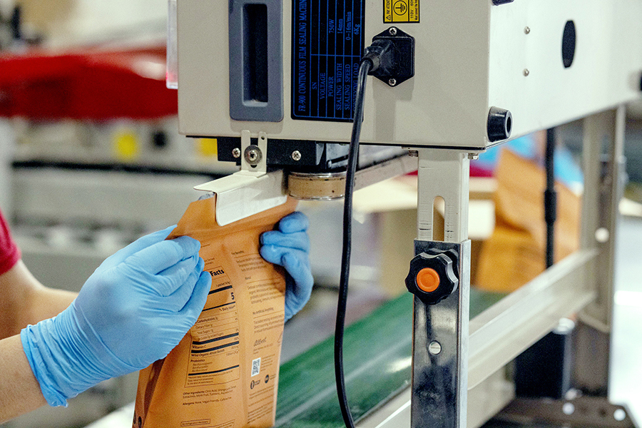 A robot sealing a bulk powder package