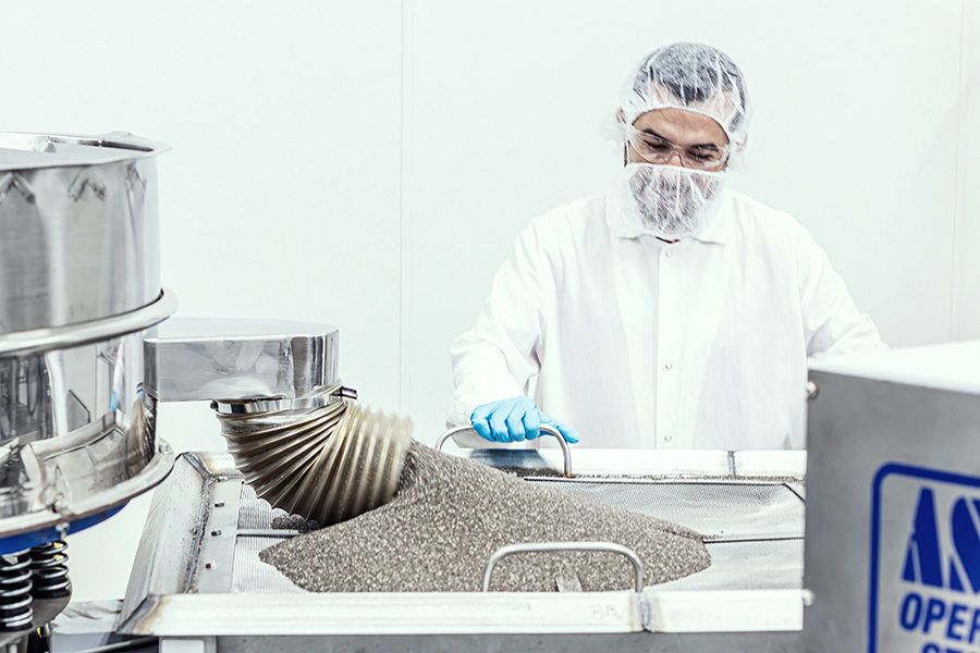 a technician supervising bulk powder packaging