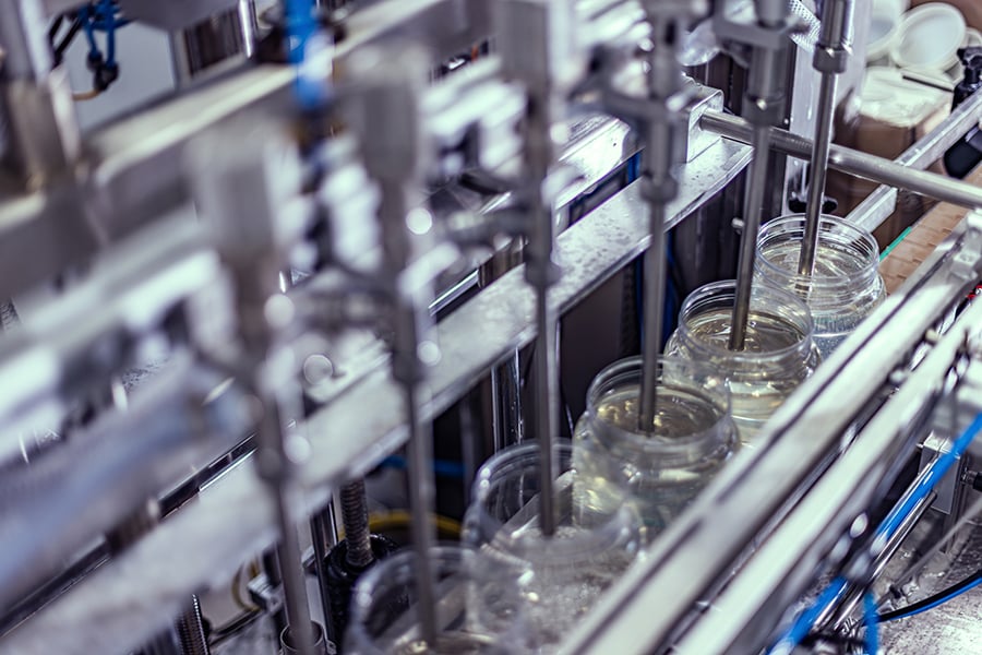 A beverage being manufactured and packaged on an assembly line A beverage being manufactured and packaged on an assembly line