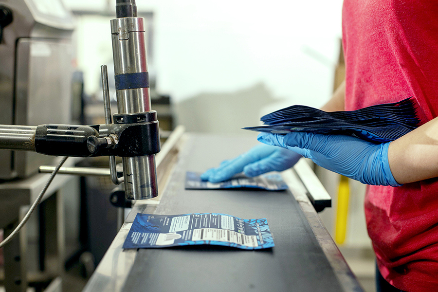Labels being added to flat packs on an assembly line