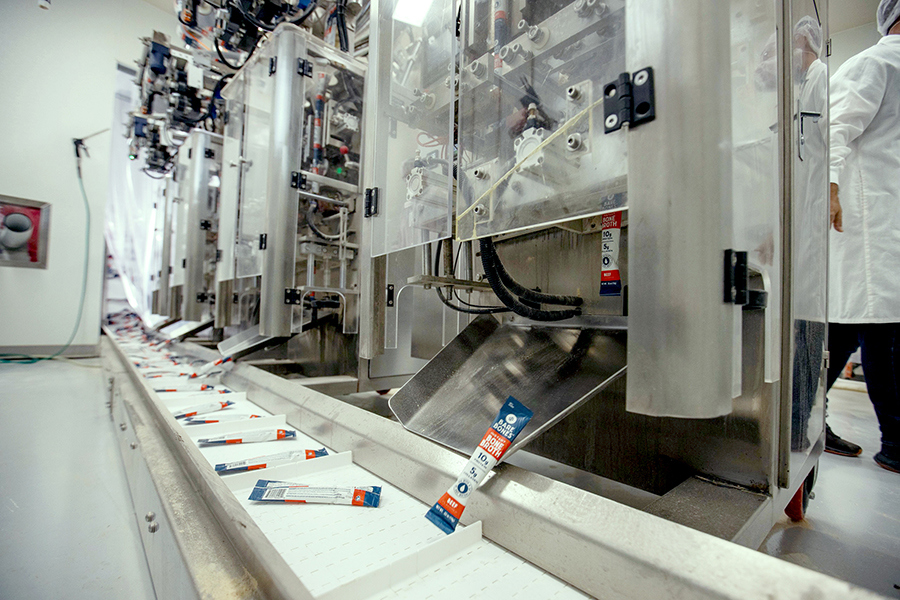 stick packs being loaded onto an assembly line