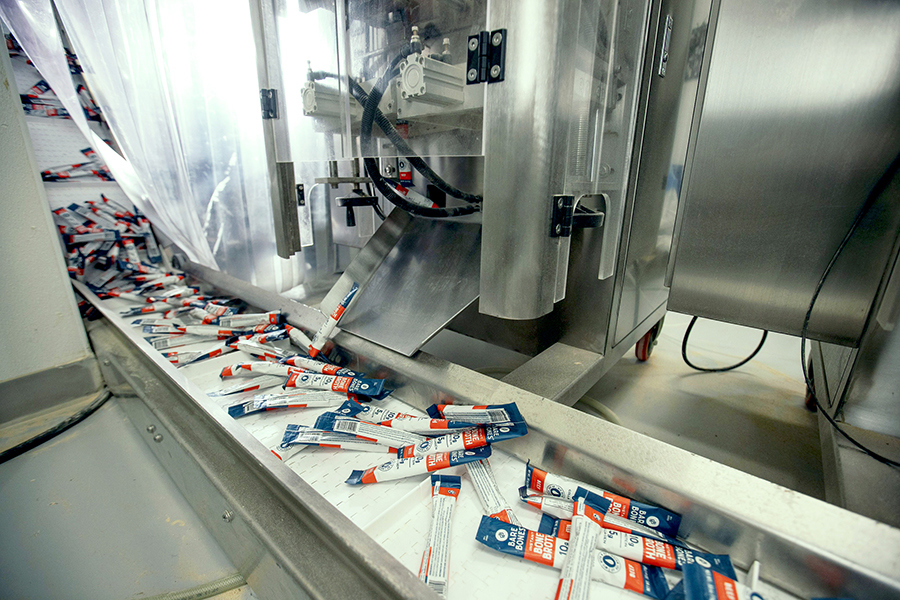 stick packs being loaded onto an assembly line
