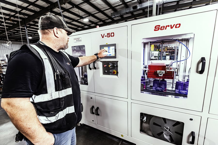 Ryder nearshoring manufacturing worker operating industrial equipment in a production facility