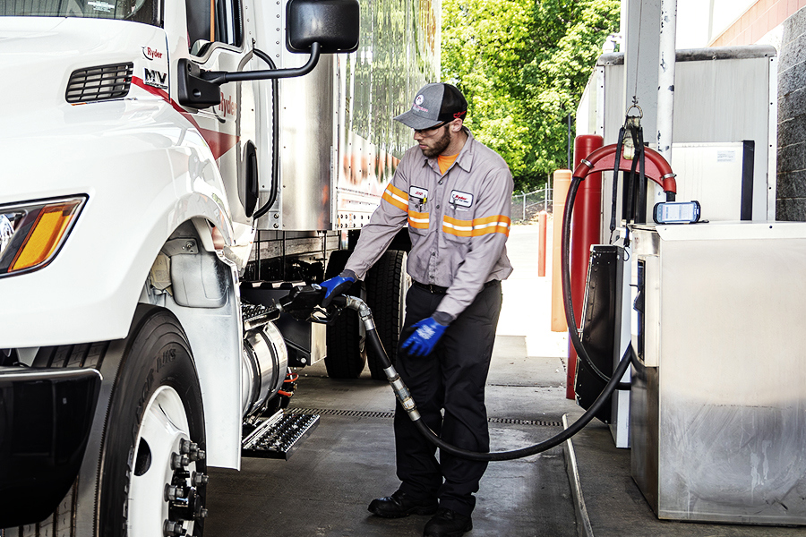 A Ryder technician filling up a semi truck