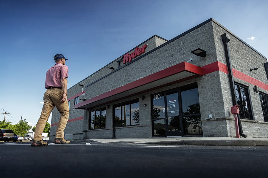 A Ryder employee walking into a Ryder rental location