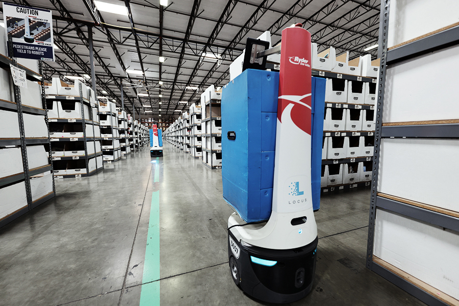 Autonomous mobile robots (AMRs) transporting goods across a warehouse floor