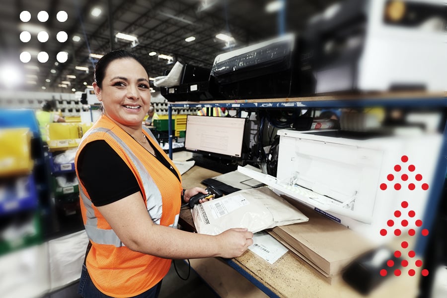 A ryder employee labeling packages at a fulfillment facility