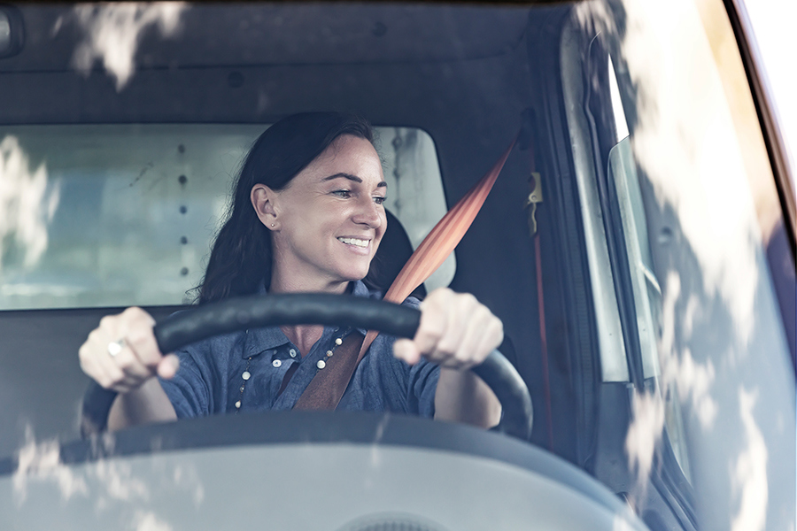A Ryder customer driving off the lot in her newly purchased box truck