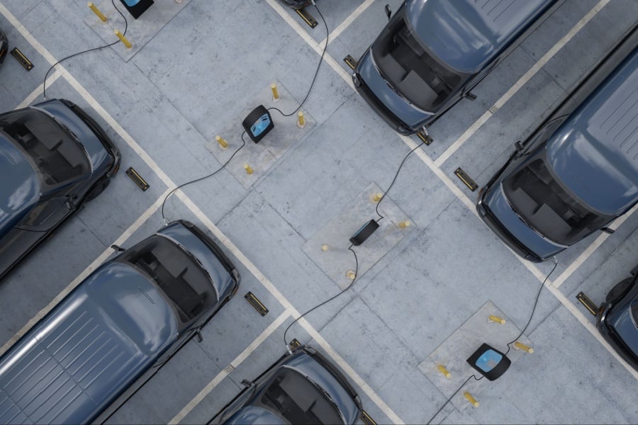 a fleet of commercial EV cargo vans on chargers a fleet of commercial EV cargo vans on chargers