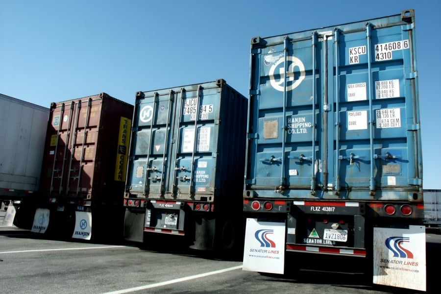 7 Strategies to Secure Your Freight from Theft Commercial trucks and trailers at a truck stop.