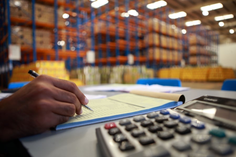 Warehouse manager looking at inventory levels Warehouse manager looking at inventory levels