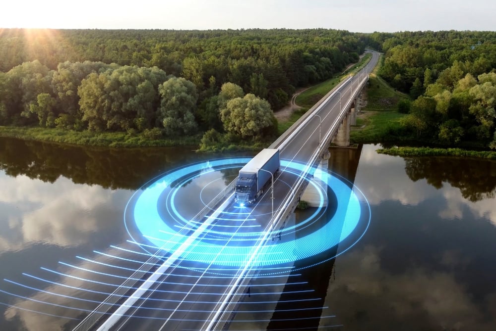 Navigating Today’s Complex Transportation Logistics Landscape Truck with digital marker on a bridge